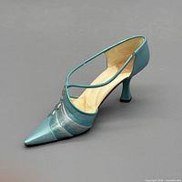 Left profile view of turquoise resin stiletto figurine