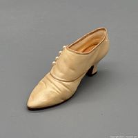 Oblique top view of cream Victorian button boot figurine