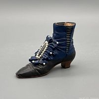 Profile view of the miniature blue and black Victorian boot figurine