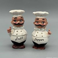 Front view of both ceramic chef shakers showing overall design and inscriptions