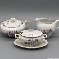 Full set showing creamer, covered sugar bowl and saucer
