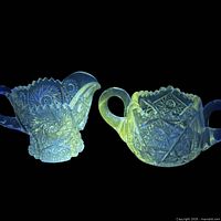 Creamer and sugar bowl glowing yellow-green under UV light