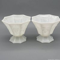 two white milk glass octagonal dishes side by side, frontal view