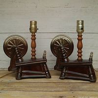 Front view of both matching ceramic and wood table lamps showing spinning wheel bases and metal sockets