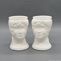 Front view of both white milk glass head vases