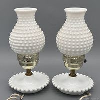 Full view of both white hobnail milk glass lamps showing shape and bases