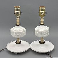 Front view of both milk glass table lamps showing overall design