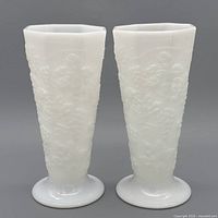 Full view of both milk glass footed vases