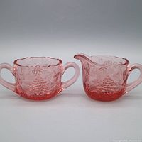 front view of both pink depression glass pieces showing overall form and pattern