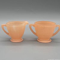Creamer and sugar bowl side by side front view