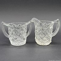 front view of both creamer and sugar bowl showing pattern and shape