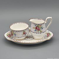 Front view of creamer, sugar bowl, tray