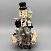 Front view of character decanter with attached mugs