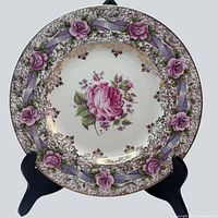 Full view of dinner plate showing floral and ribbon border