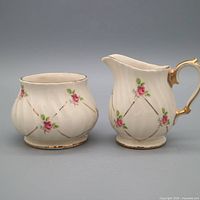 Front view of Sadler creamer and sugar bowl showing rose motifs and gold trim