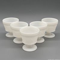 Group shot of five white milk glass sherbet cups