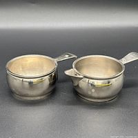 front view of both stainless steel pieces showing size, finish and tarnish