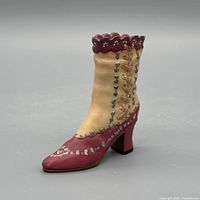 Left side view of resin two-tone boot figurine