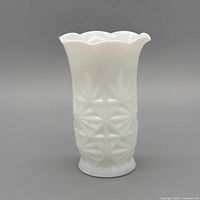 Front view of white milk glass vase showing geometric starburst pattern