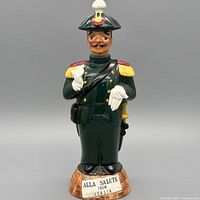 Front view of ceramic Italian soldier decanter showing stopper and inscription