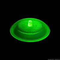 lid under UV light showing green fluorescence