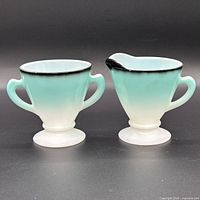 front view of both glass pieces showing gradient color and footed bases