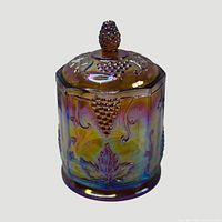 Full view of covered jar showing shape, pattern and iridescence