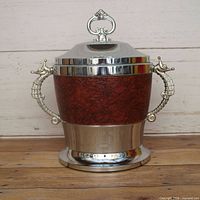 Front view showing leather wrap, silver lid, base and seahorse handles