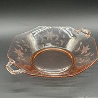 Oblique view showing bowl shape, color, handles and etched floral pattern