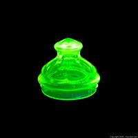 Lid glowing bright green under UV showing uranium content