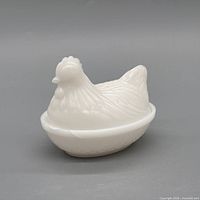 side view of milk glass hen on nest dish assembled