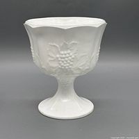 Front view of white milk glass compote showing grapevine motif