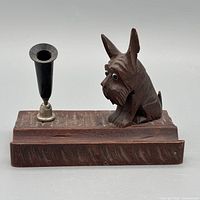 Front view of carved wood Scottie dog, pen socket visible