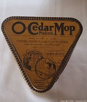 Top view of triangular O-Cedar Mop Polish tin showing main logo and graphics