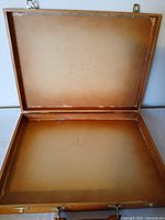 Case open showing interior peeling backing and hinges