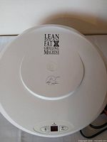Top view of white George Foreman grill lid with logo