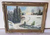 Front view of framed winter landscape painting