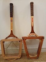Front view of both racquets inside wooden presses
