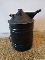 Front view showing spout, cap, bail with wooden handle, body condition