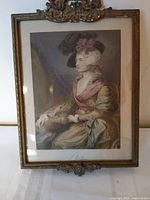 Front view showing framed mezzotint print and ornate crest