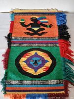 Full view of front showing both main motifs and fringe condition