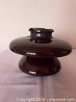 front view of brown ceramic suspension insulator