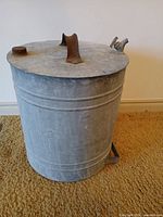 Top view showing screw cap, arched handle and tap spout on galvanized can