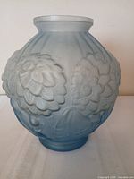 Front view of Lalique frosted blue glass vase showing floral relief