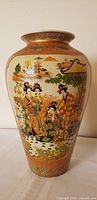 Full view of vase front showing Geisha scene and decorative bands