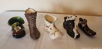 Front view of all five ceramic boot figurines