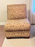 Front view of beige and brown patterned slipper chair