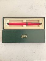 Pen in box showing hot pink barrel and Cross box interior