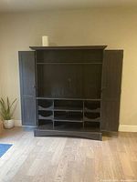 Front view doors open showing TV space, shelves and wine cubbies