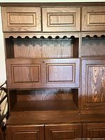 full view of center and right sections showing paneled doors, open shelves, scalloped valance